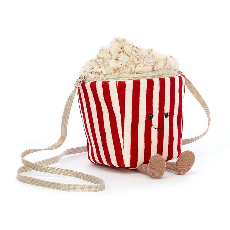 Stuffed popcorn bag with striped tub, happy face, and feet sitting at an angle