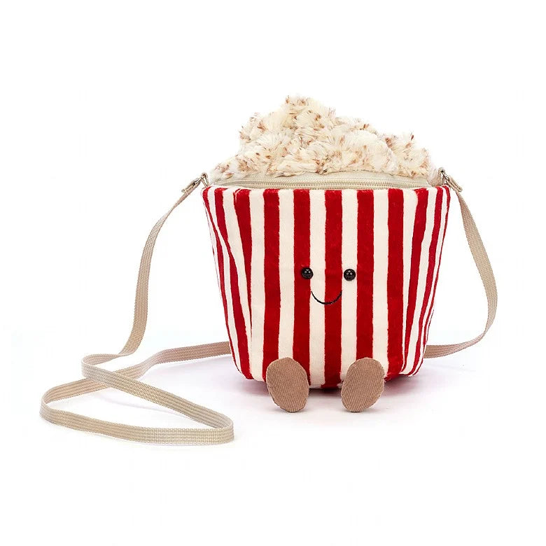 Stuffed popcorn bag with striped tub, happy face, and feet facing forward