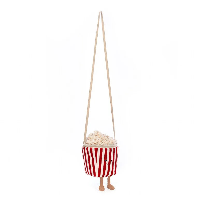 Stuffed popcorn bag with striped tub, happy face, and feet hanging by its strap