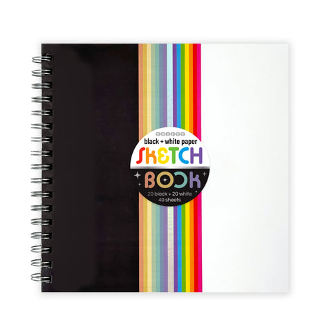 Image shows a cover of a black & white sketchbook. Half is black, half is white, and a rainbow runs down the middle.