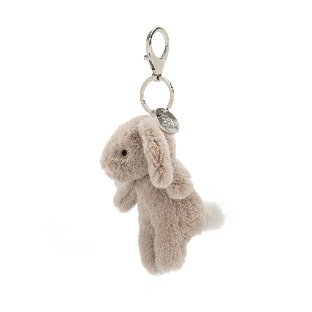 Side view of beige bunny hanging from clip keychain