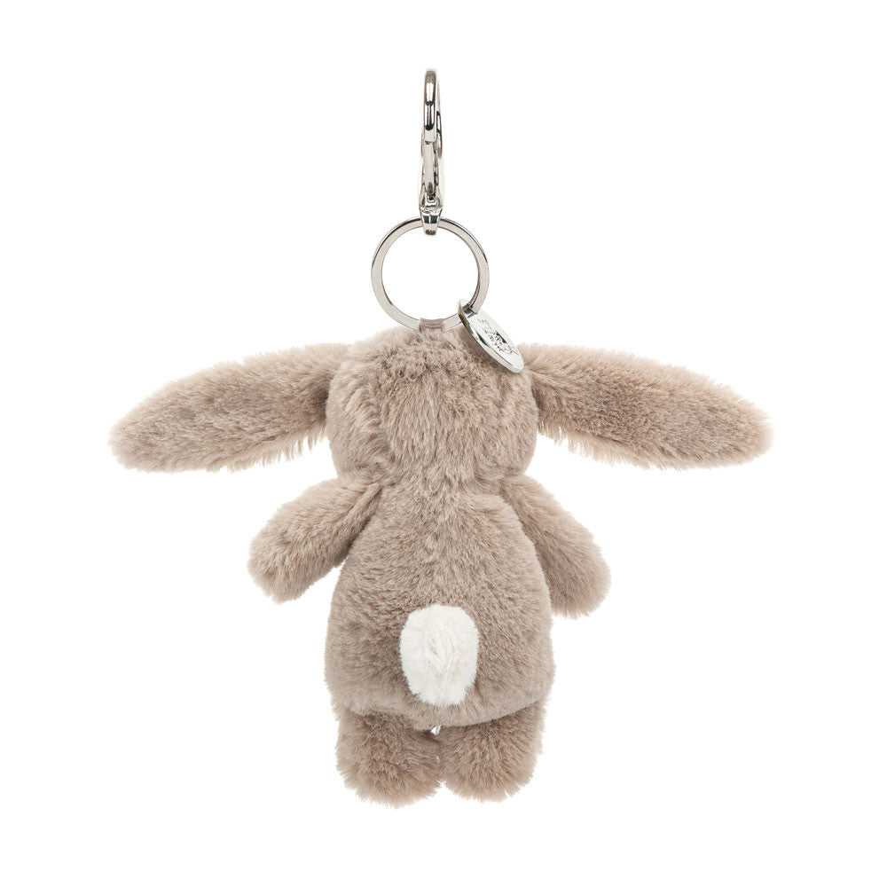 Back view of stuffed beige bunny hanging from clip keychain