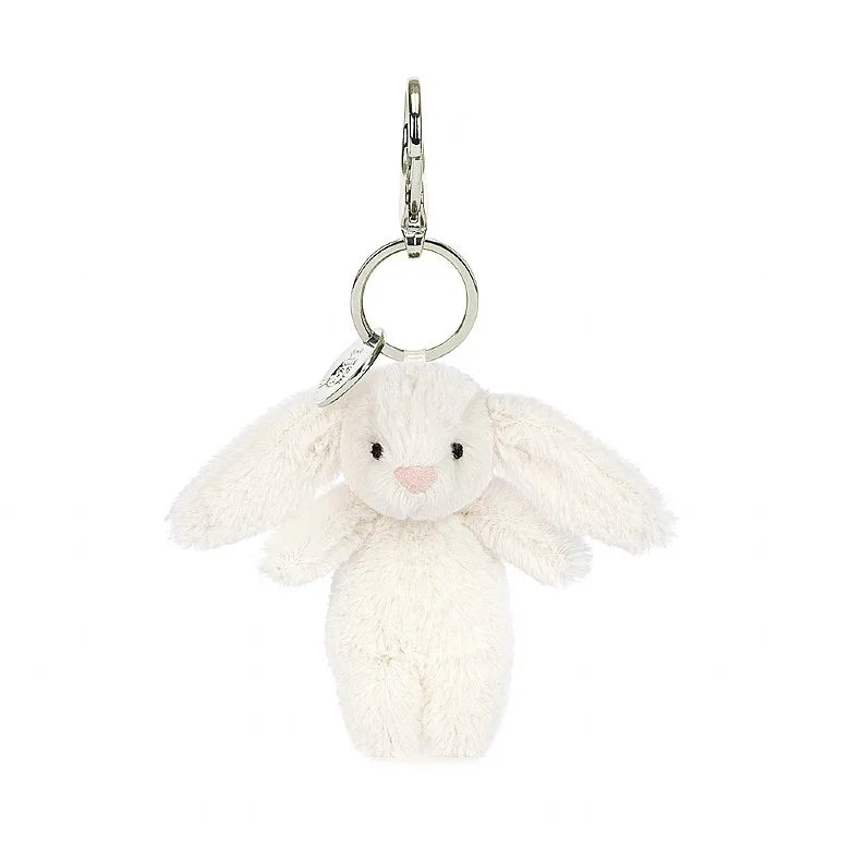 Stuffed cream bunny hanging from clip keychain