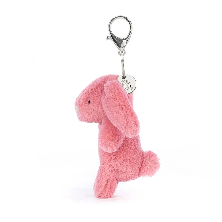 Side view of Stuffed pink bunny hanging from a clip keychain