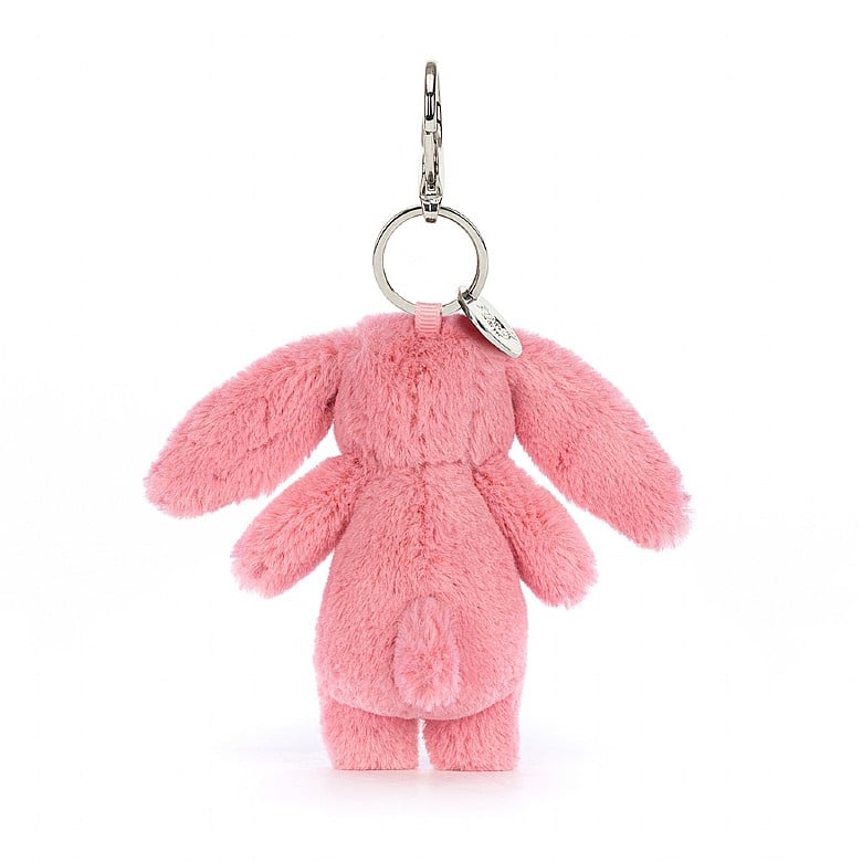 Back view of a stuffed pink bunny hanging from a clip keychain