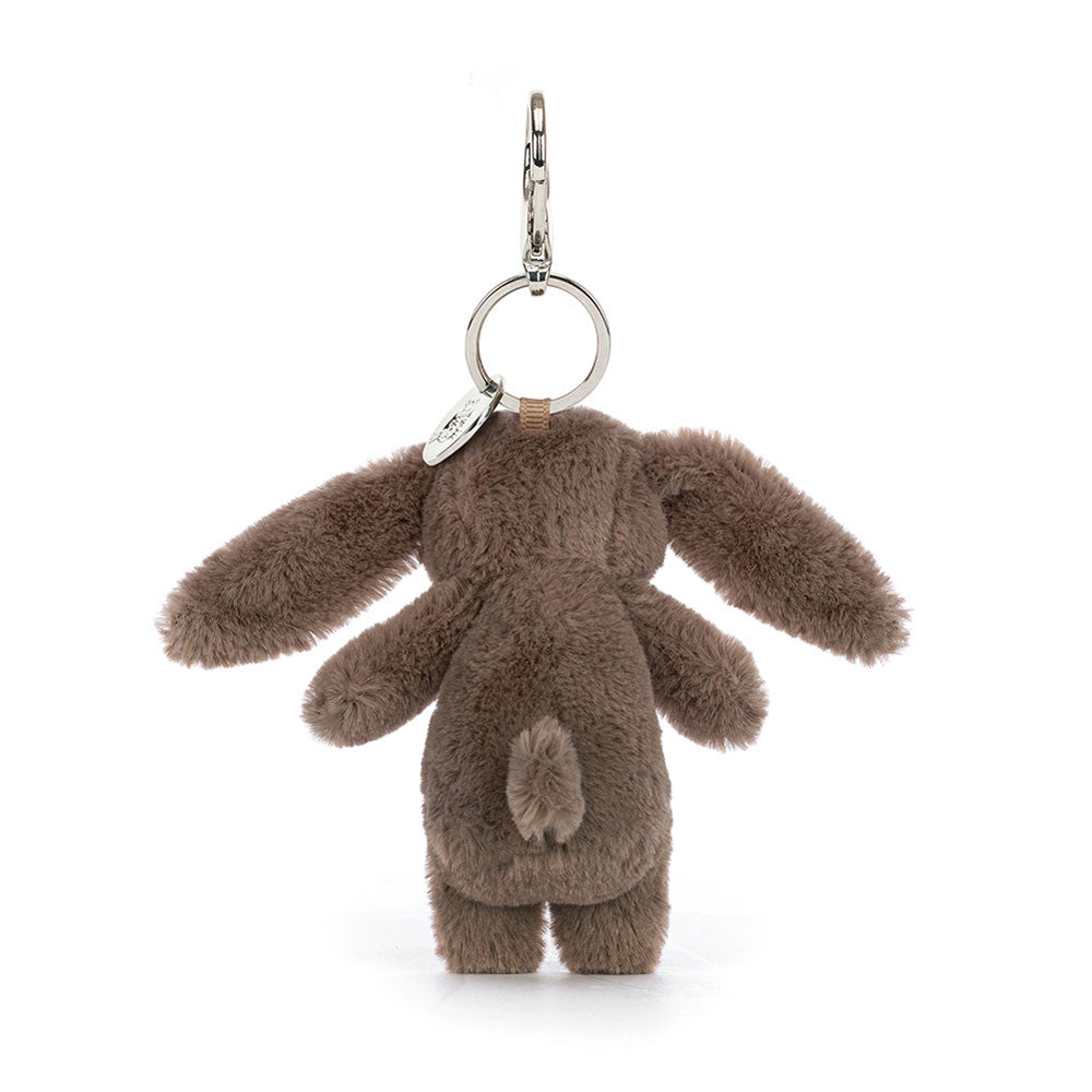 The back view of a stuffed brown bunny hanging from a clip keychain