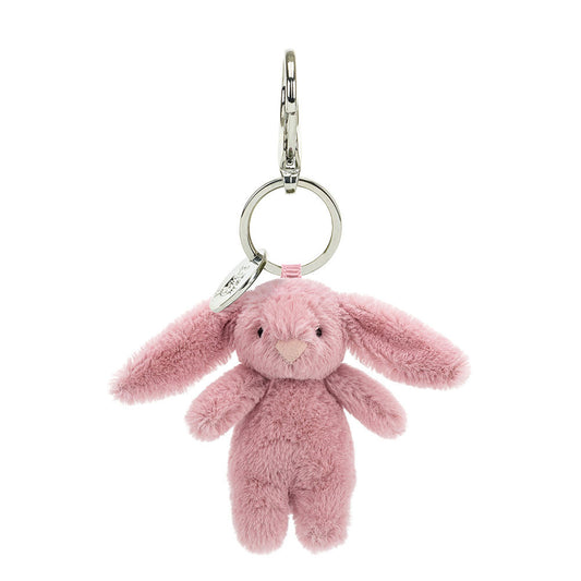 A light pink stuffed bunny hanging from a clip keychain