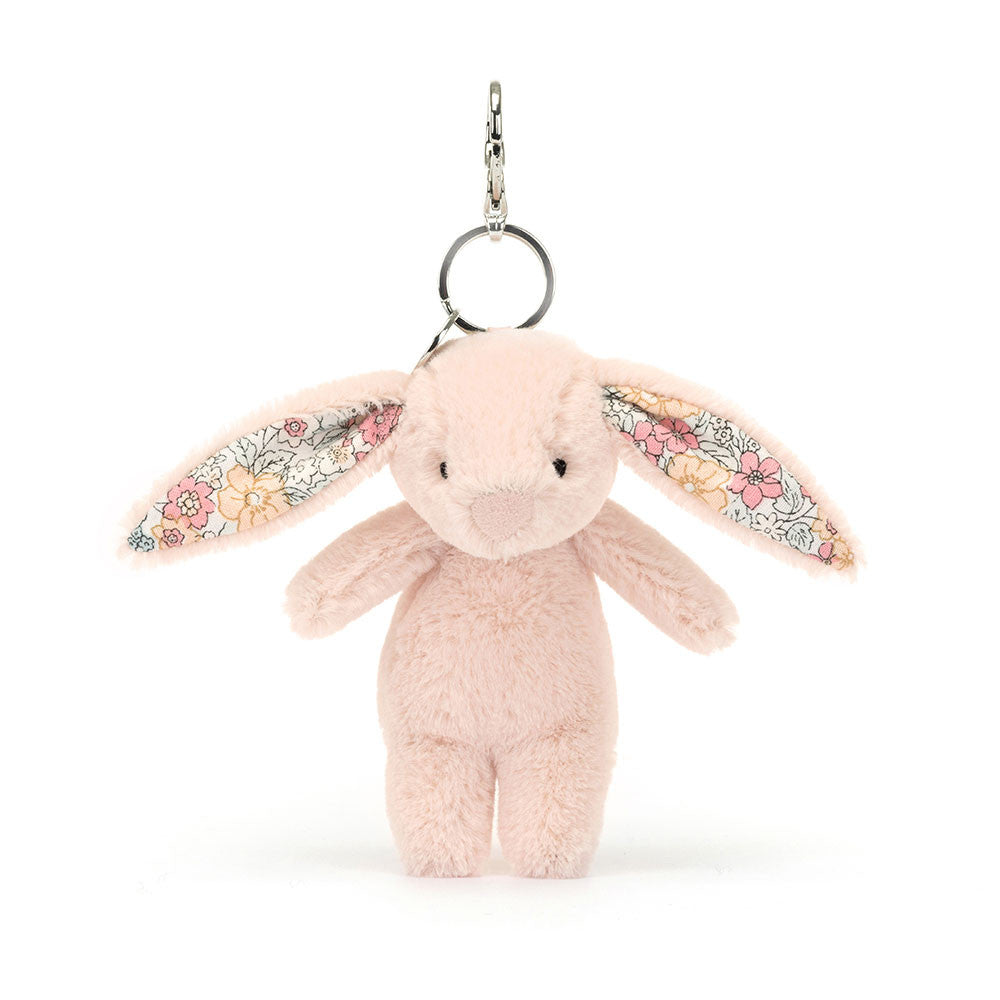 Stuffed blush bunny with floral fabric inside ears hanging from clip keychain