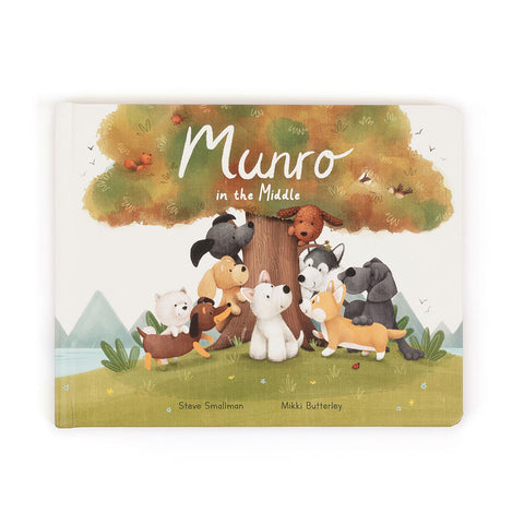 Image shows a book titled "Munro in the Middle". It has various Jellycat dogs under a tree.