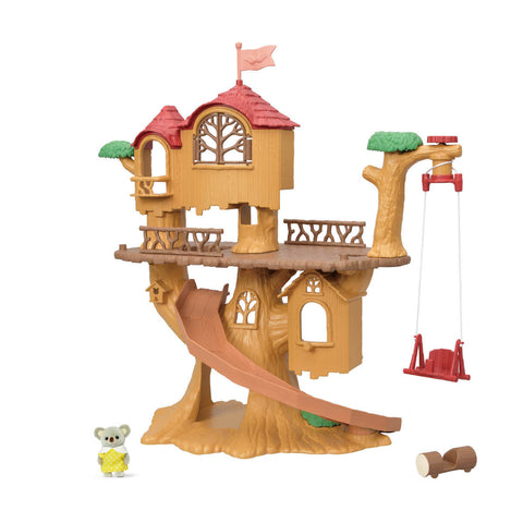 Toy treehouse with slide, swing, and small koala figure on a white background