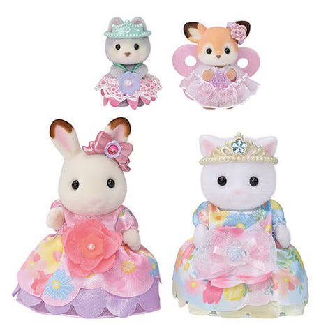 Four toy animals in decorative dresses and crowns on a white background