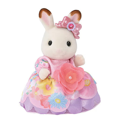 Toy rabbit figure with a pink dress and flower details on a white background