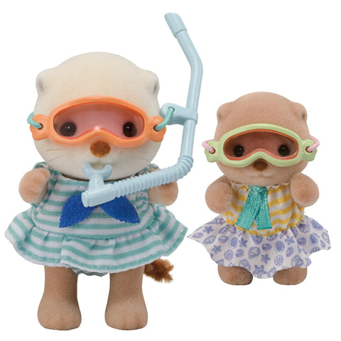 Two sea otter toys with snorkeling gear on a white background