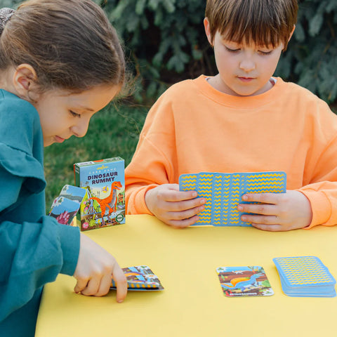 Image shows two children playing the dinosaur rummy game