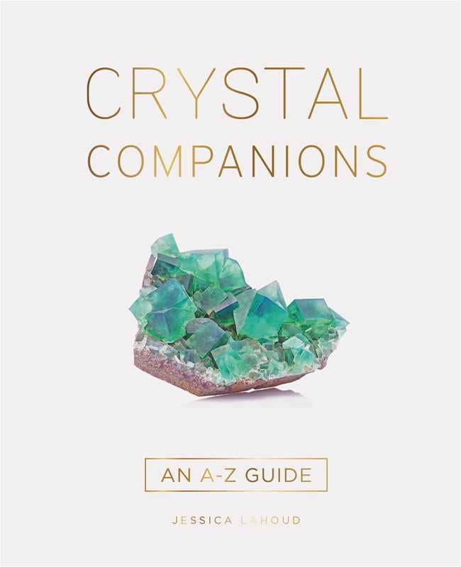 A white book cover with the title "Crystal Companions". Below the title is a blue/green raw crystal