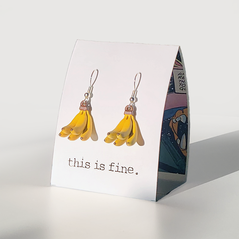 Image shows a pair of earrings in the shape of a bunch of bananas. They hang from silver wires.