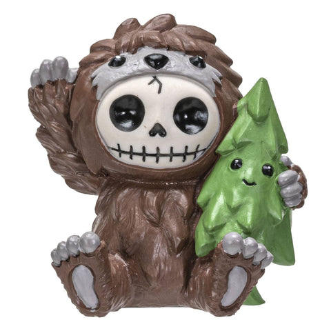 Image shows a resin bigfoot with a skeleton-like face. He is holding an evergreen tree with a smiley face.
