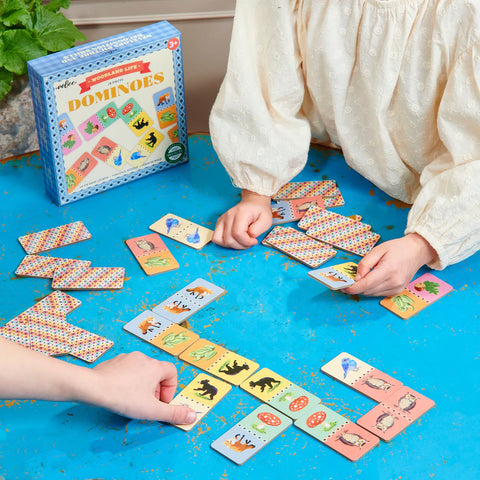 Image shows two children playing the dominoes game