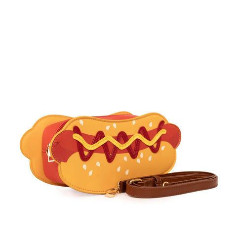 Image shows a PU leather hot dog handbag with a dark brown strap in front of it.