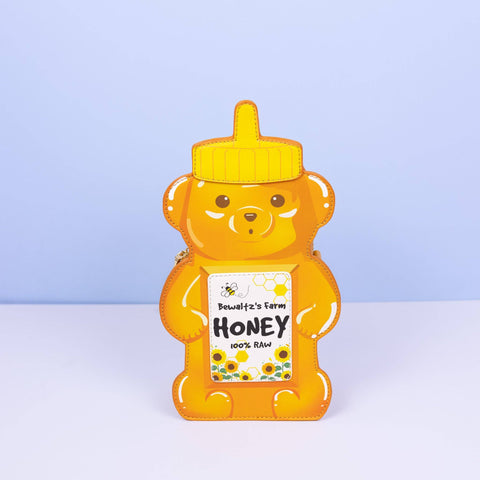 Image shows a handbag shaped like a bear-shaped honey bottle