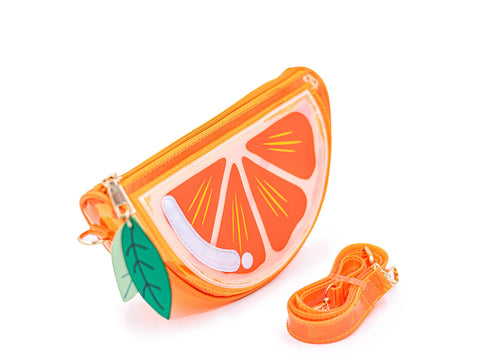 Image shows a jelly-like handbag in the shape of an orange slice. It has an orange strap in front of it.
