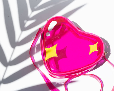 Image shows a jelly-like handbag in the shape of a pink heart. The heart has two small yellow stars on it.