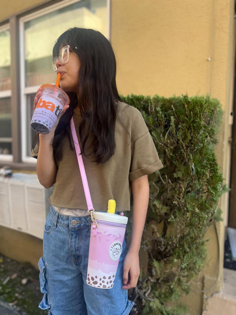 Image shows a woman wearing the boba milk tea bag as a crossbody bag