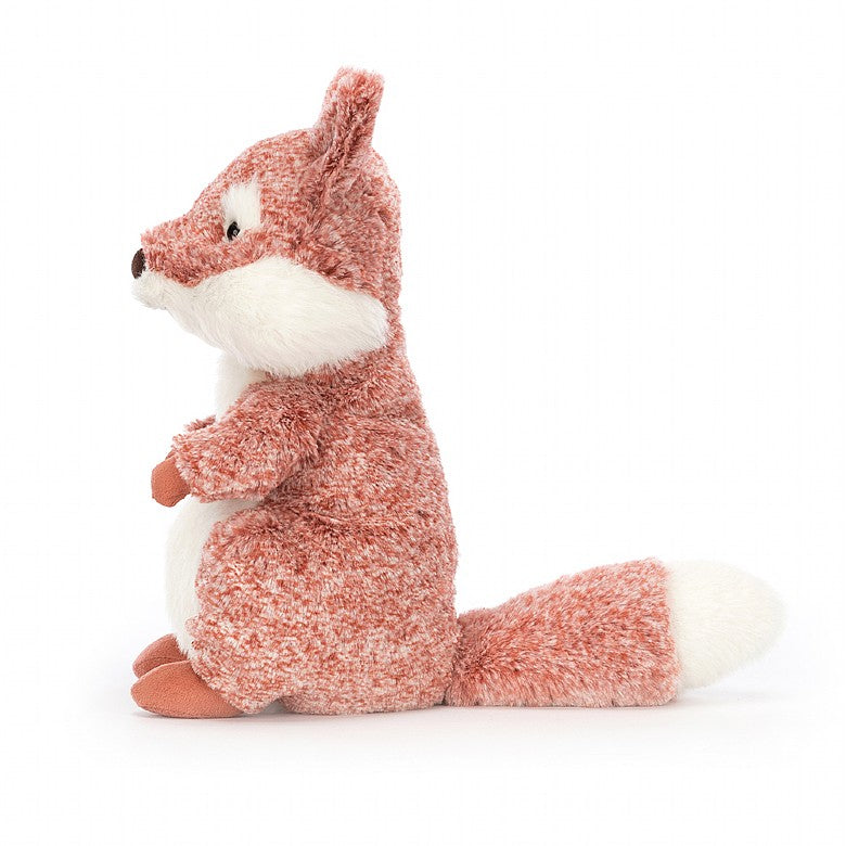 Side view of A stuffed fox with patterned red fur