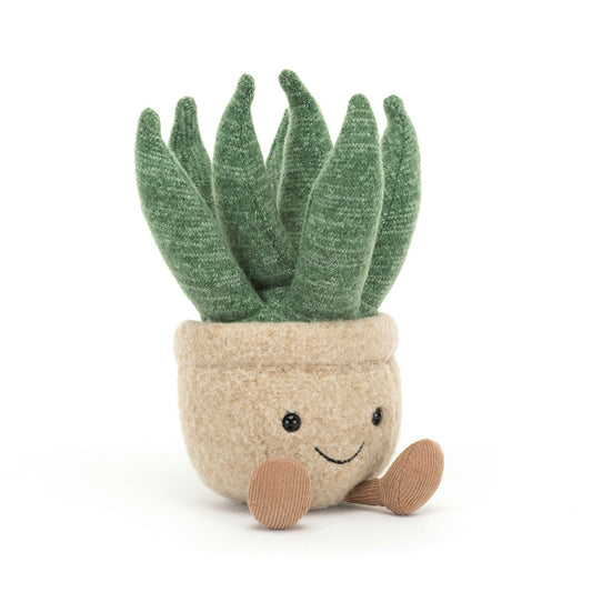 A small potted aloe vera plant. The pot is tan and has a smiley face and dangly feet