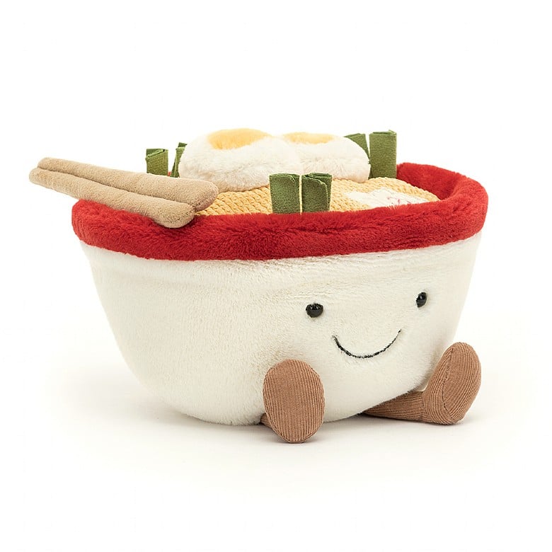 A stuffed bowl of ramen with a smiley face and feet