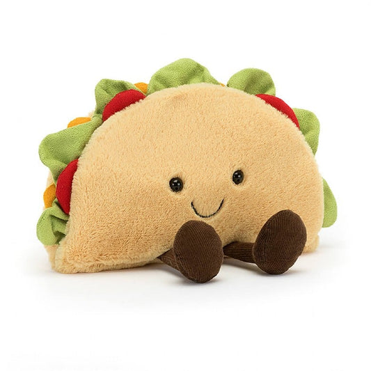 A stuffed taco with a smiley face and feet