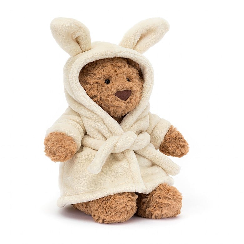 A brown teddy bear wearing a bathrobe with bunny ears