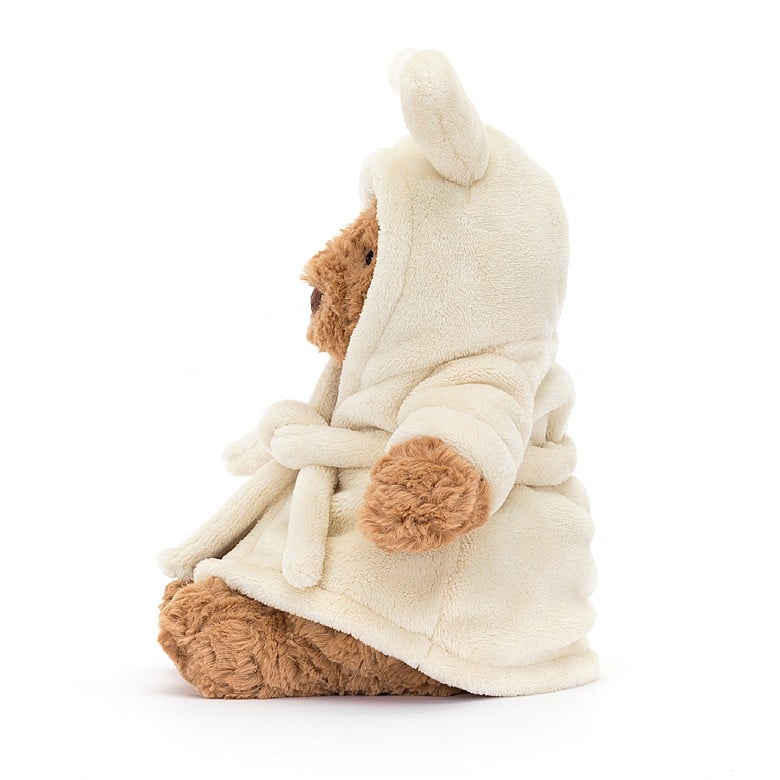 The side view of the same teddy bear in a bathrobe