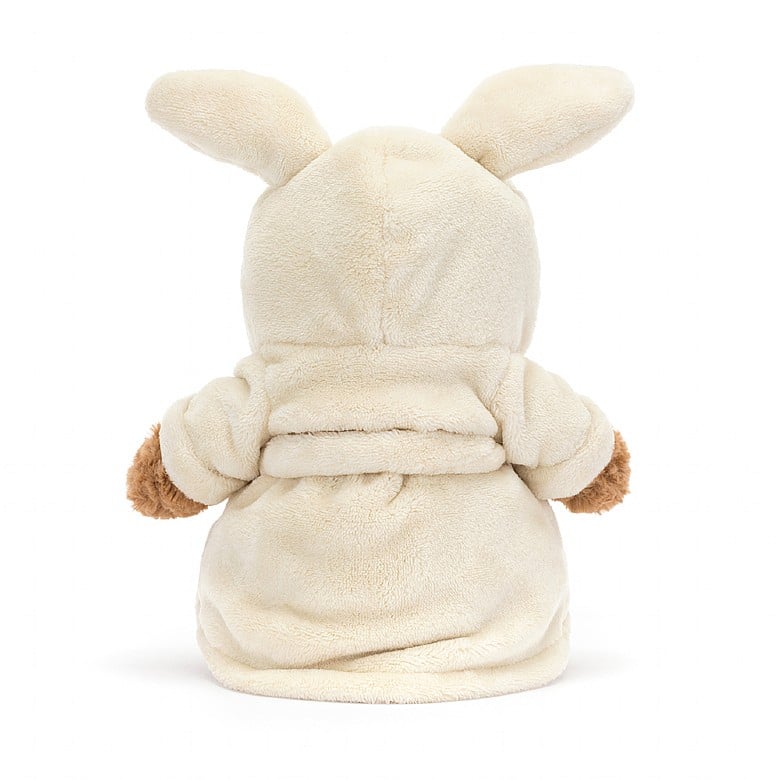 The back view of a teddy bear in a bathrobe with bunny ears