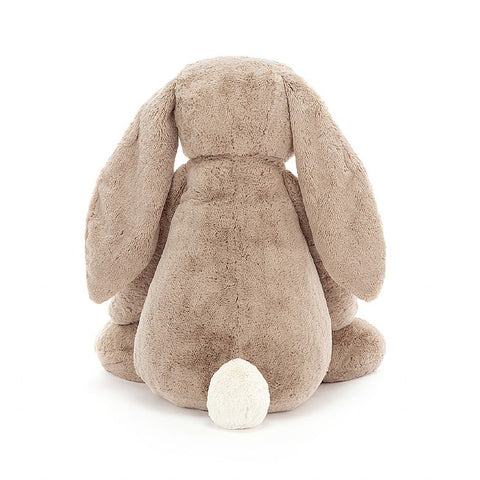 A back view of the large, beige-colored stuffed bunny