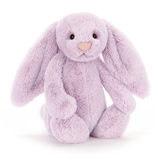 A seated stuffed lilac colored bunny with floppy ears and a pink nose