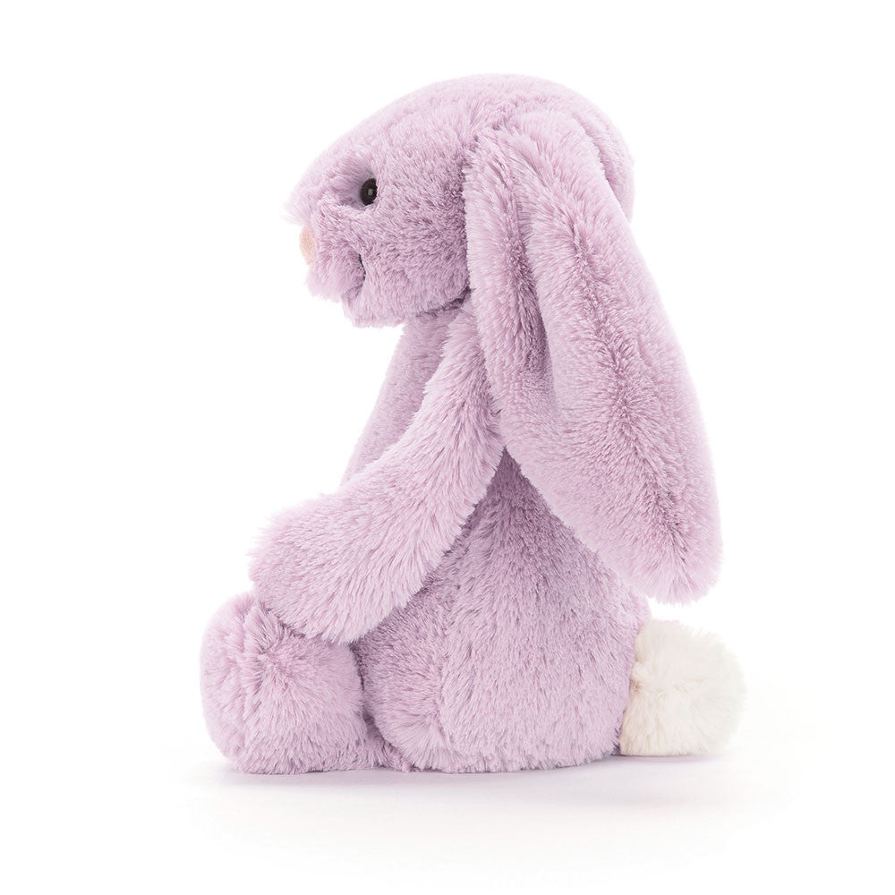 A side view of the same lilac stuffed bunny