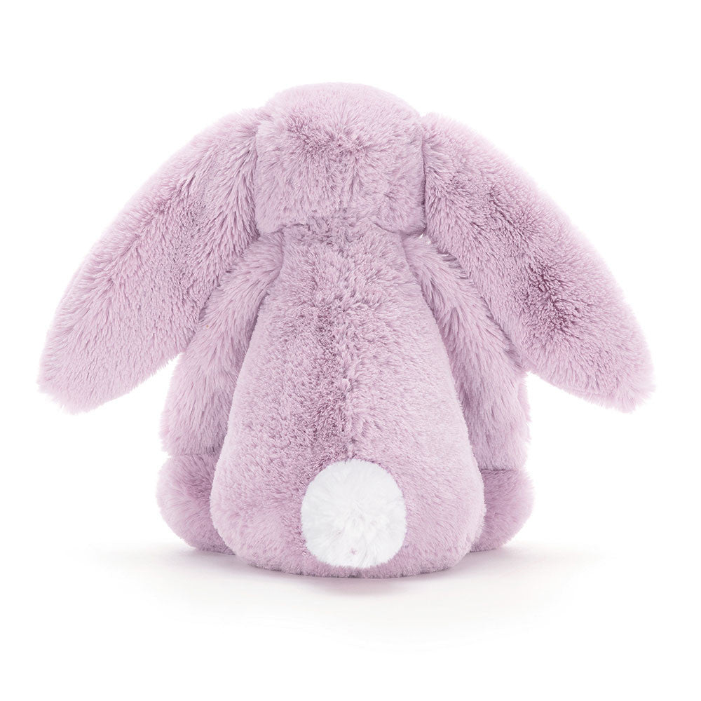 The back view of the same lilac stuffed bunny with a white puffy tail