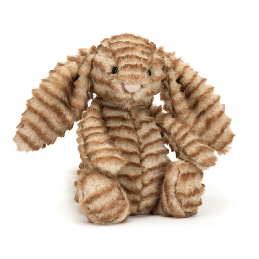 A stuffed bunny with striped golden brown fur, floppy ears, and a pink nose