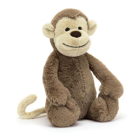 Image shows a soft-looking stuffed monkey. Its body is brown while its face, ears, and tail are cream.