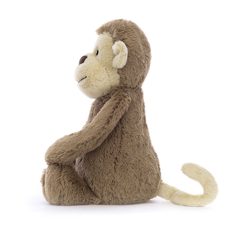 Image shows a side view of the stuffed monkey