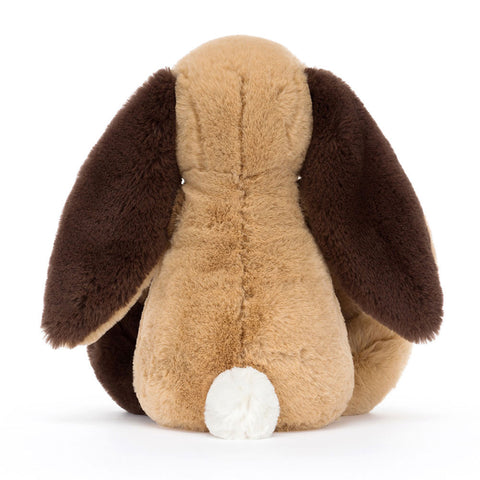 Image shows a back view of the stuffed patchwork bunny. Its tail is white.