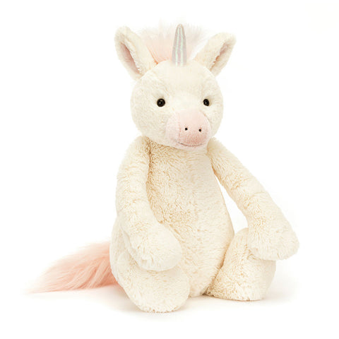 Image shows a white stuffed unicorn with a silver horn and light pink mane, tail, and nose.