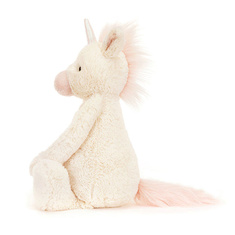 Image shows a side view of the stuffed unicorn