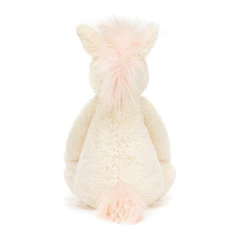 Image shows a back view of the stuffed unicorn