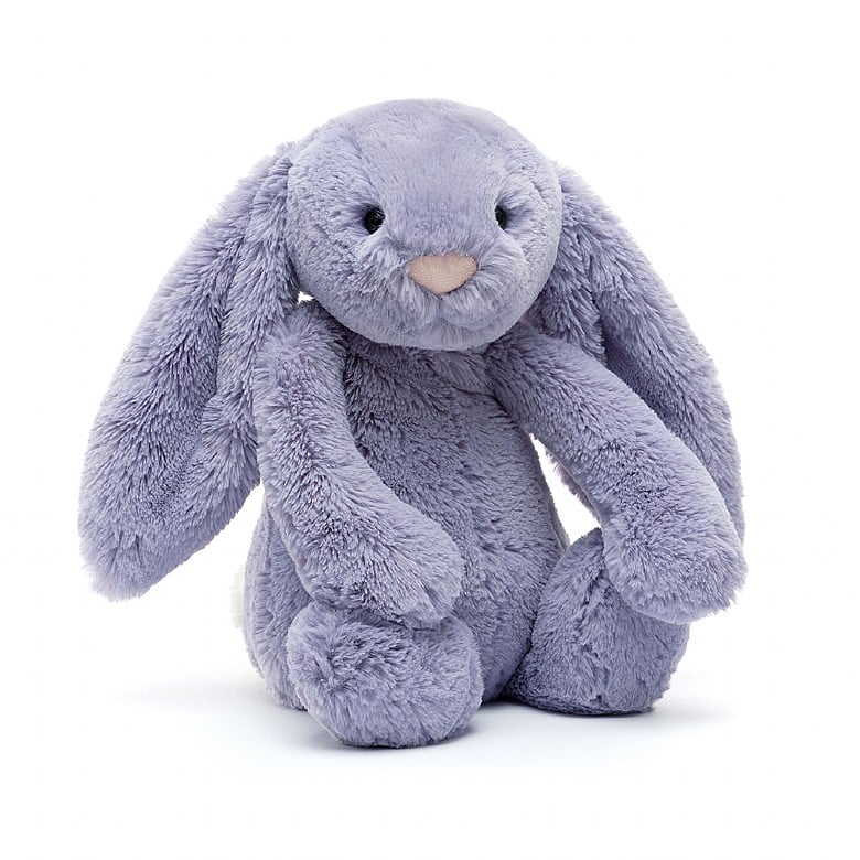 A stuffed lavender colored bunny with floppy ears and a pink nose