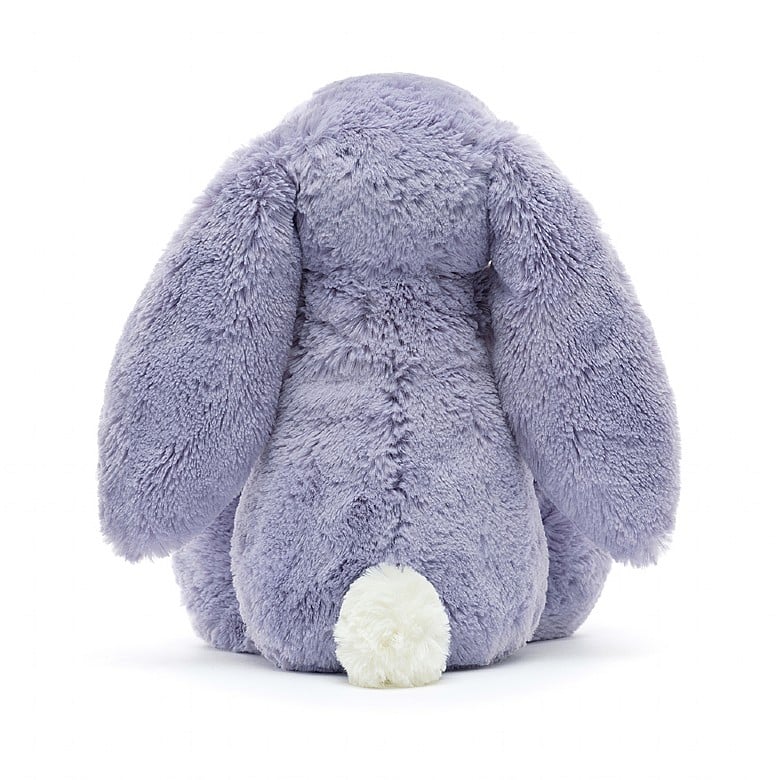 A back view of the same stuffed bunny, showing its fluffy white tail