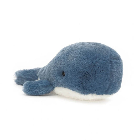 A blue stuffed whale with a while belly