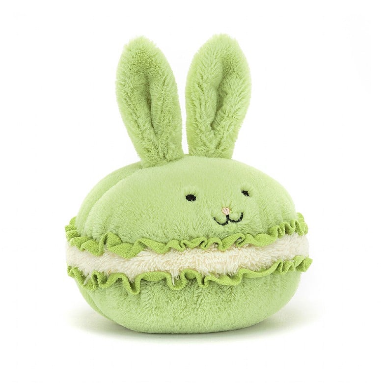 A light green stuffed macaron with a bunny face and ears