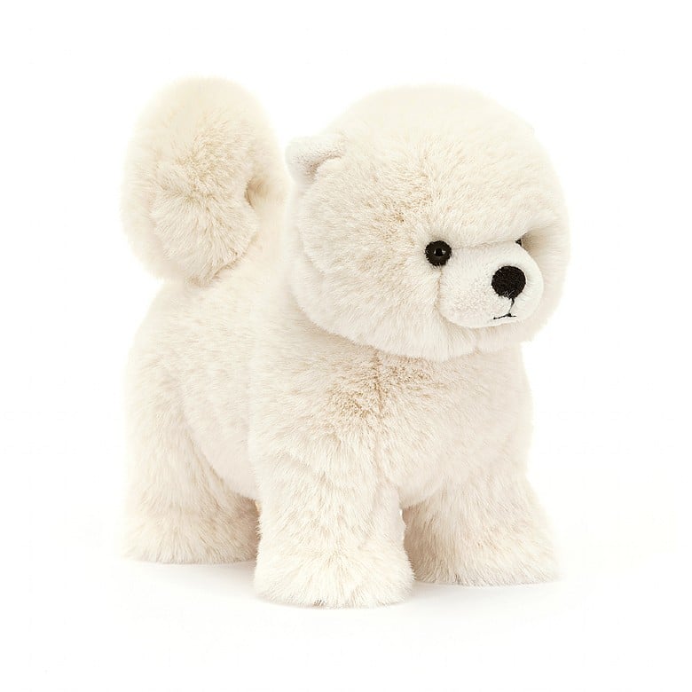 A stuffed white Pomeranian. The dog is standing and has a curly tail.